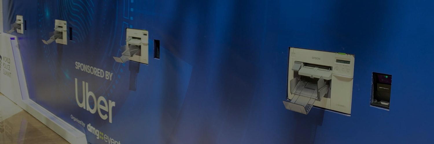 Wall‑mounted Epson badge printers installed at an event, ready for fast attendee badge printing.